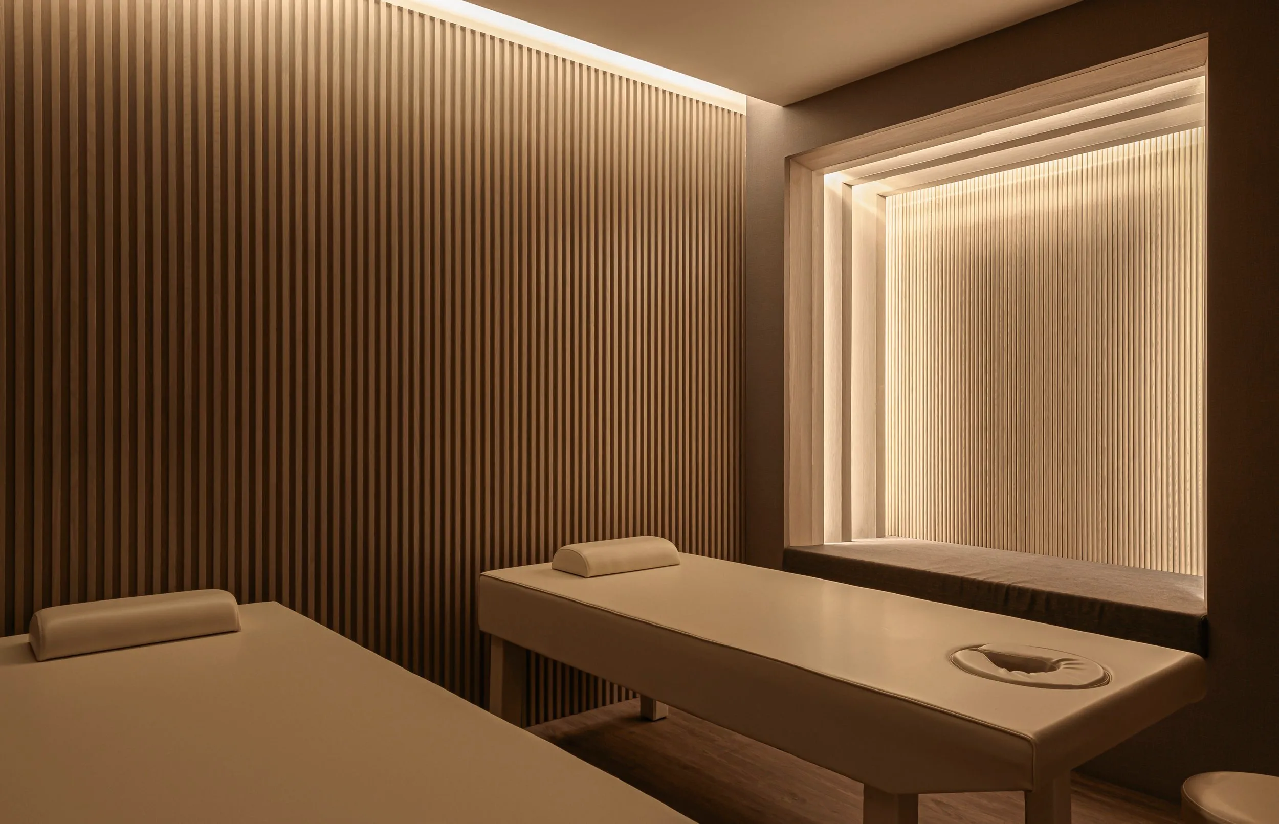 Soft architectural lighting adds warmth to the treatment environment.