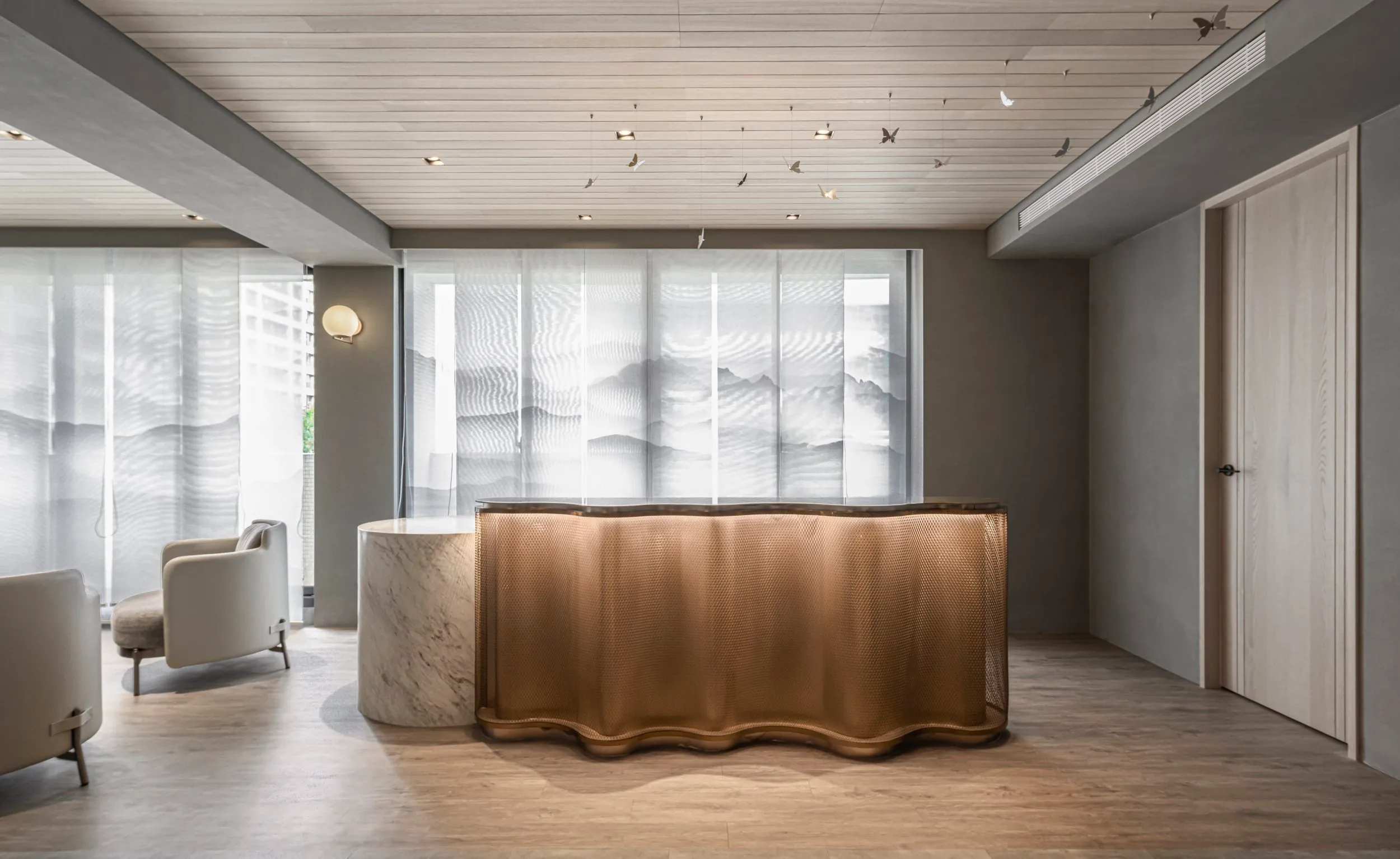 The reception area brings together softness, structure, and quiet refinement.