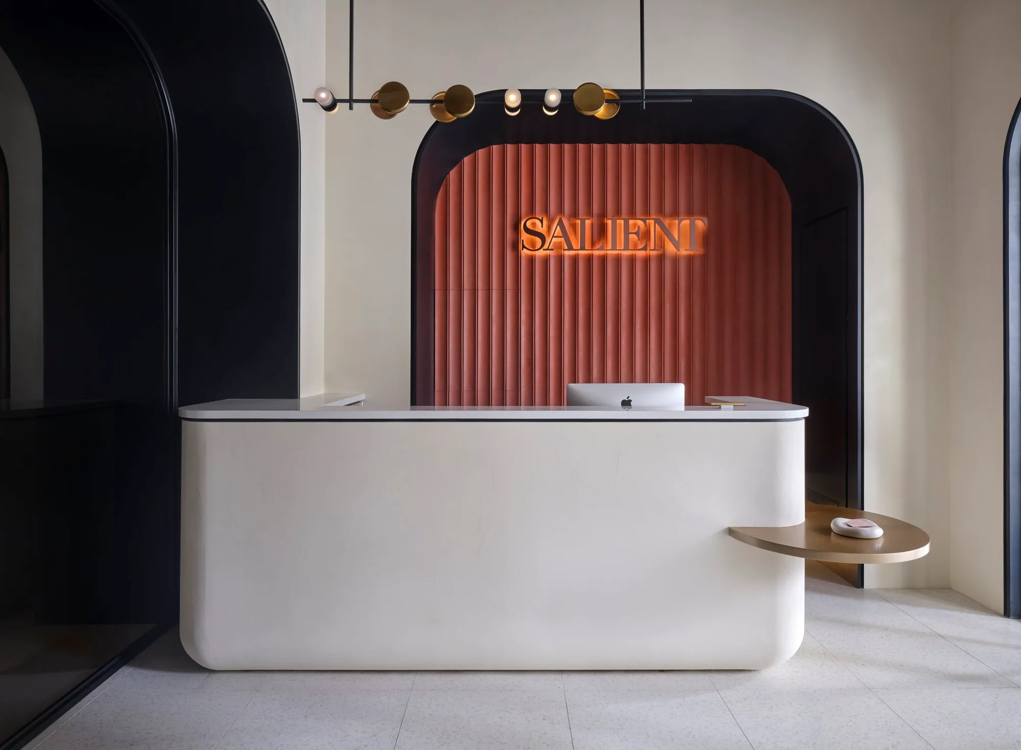 The reception area reflects the brand’s clean lines, warmth, and quiet confidence.