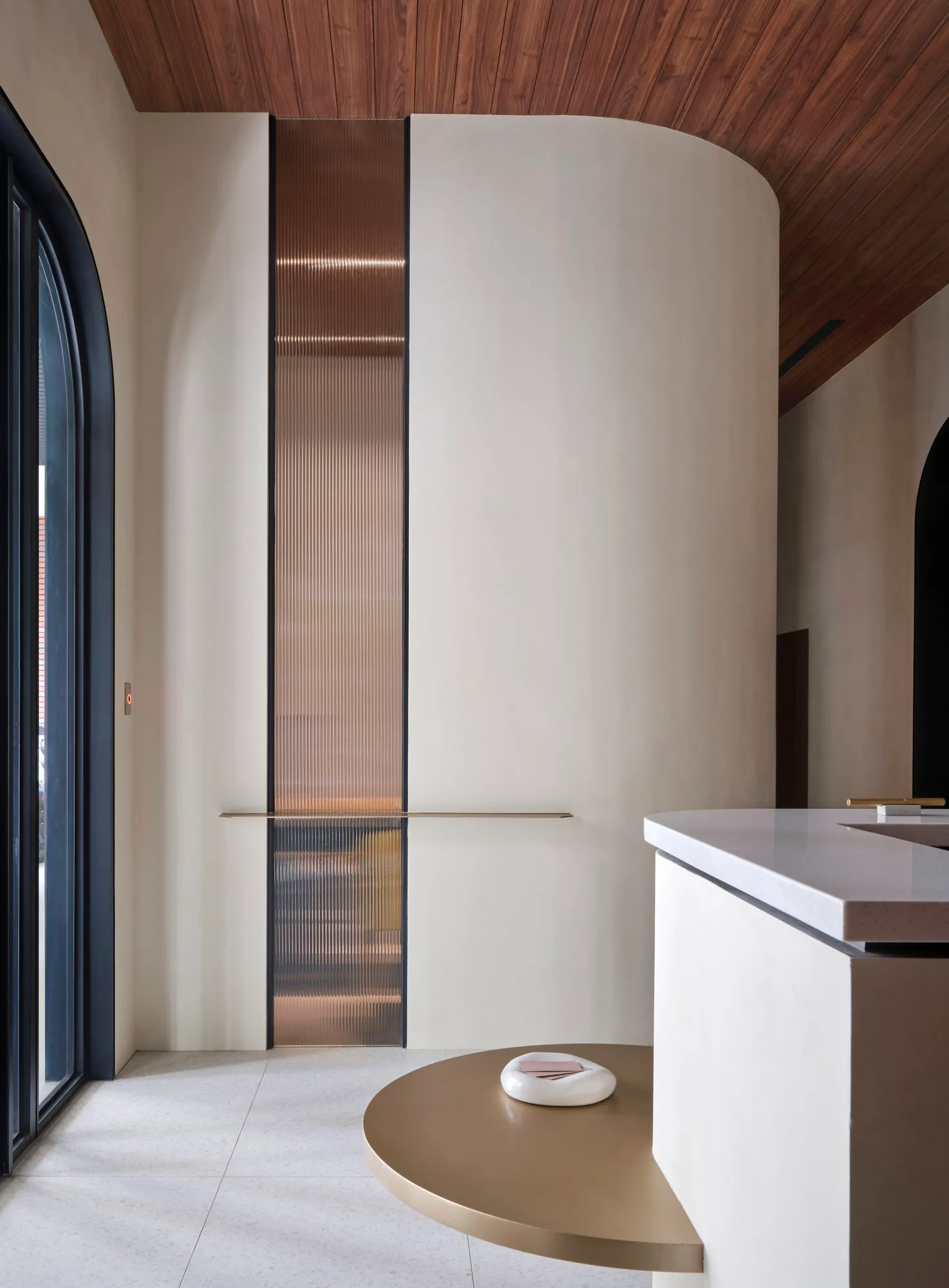 Curved forms and rich materials create a distinctive sense of flow through the space.