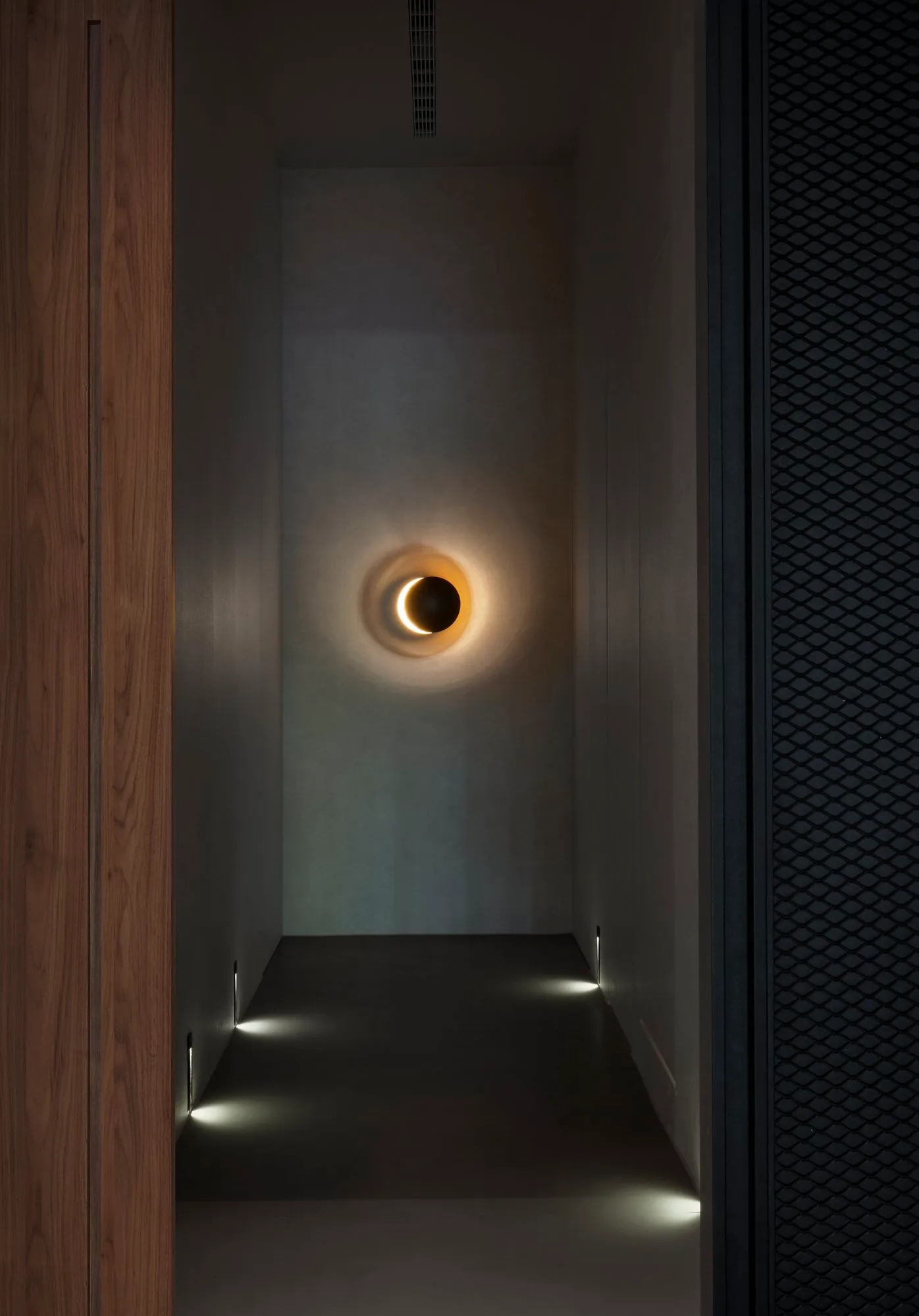 Subtle lighting and shadow add depth to the clinic’s interior architecture.