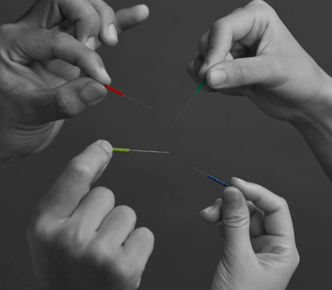 Hands holding acupuncture needles in Salient media feature
